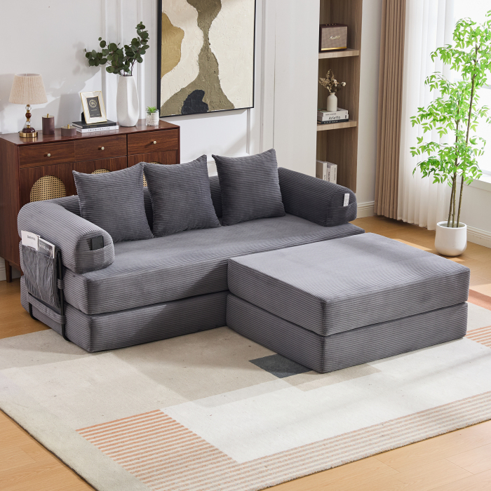 Sofá modular de pana gris oscuro con otomana y cojines